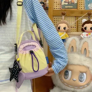 Korean style casual colorblock canvas crossbody bag with cute star pendant for women daily use.