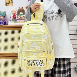 Stylish yellow camouflage backpack for women, large capacity casual student school bag daily travel.