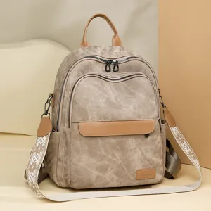 Zaino da donna in tela elegante per il commuting e la scuola. Design chic con spallacci decorati.