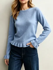 Light blue knit sweater detail, ruffled hem and cuffs, comfortable crewneck sweater close-up.