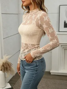 Detailed view of women sheer lace mock neck long sleeve top showing delicate floral mesh texture.
