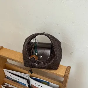 Chic woven dumpling shoulder bag for women, premium leather crossbody daily handbag.