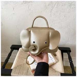Detailed view of the cute gold elephant shaped crossbody handbag with unique design.