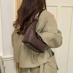 Women's woven leather underarm shoulder bag, stylish casual dumpling handbag for daily commuting.