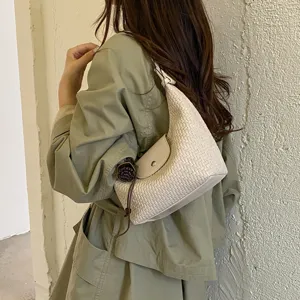 Woven underarm shoulder bag detail, stylish beige dumpling handbag for women commuting.