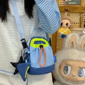 Korean casual crossbody phone bag with star pendant and trendy drawstring design for daily commute.