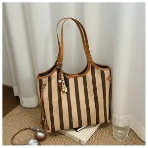 Grande borsa a tracolla a righe con finiture in pelle marrone e ciondolo con perline chic.