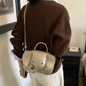 Cute gold elephant shape crossbody bag for women, creative PU leather mini shoulder purse, chic.