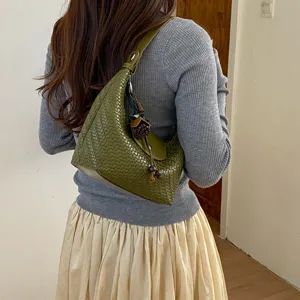Chic green woven leather hobo bag for women, stylish dumpling shoulder bag for daily commute.