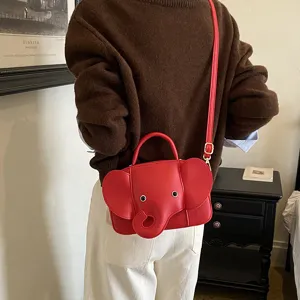 Red elephant shaped shoulder bag detail showing cute 3D ears and trunk design with metal strap.