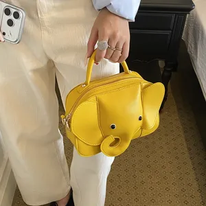 Cute yellow elephant shape crossbody bag with top handle, unique cartoon style handbag for women.