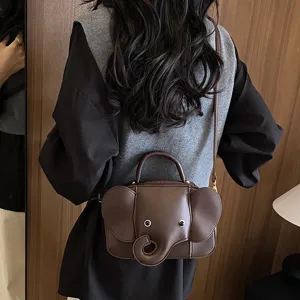 Detail shot of a cute brown elephant shaped shoulder bag worn on back, showing unique design.
