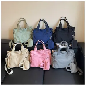 Sac cabas en toile de style japonais décontracté avec poches multiples et petite pochette.