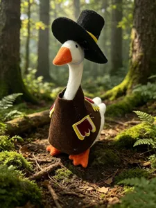 Close-up detail of the cute plush goose in a Thanksgiving turkey costume and hat scene.