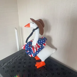 Detailed view of the 7-inch patriotic goose figurine wearing a cute cowboy hat and US flag scarf.