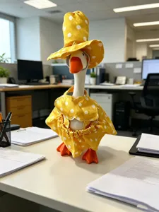 Detail shot of a 7-inch little goose plush toy wearing a cute yellow polka dot sun hat and dress.