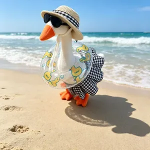 Detailed closeup of the summer beach vacation plush goose toy set with hat, sunglasses, and skirt.