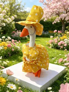 Ceramic yellow polka dot goose figurine detail, cute dress and hat garden decor close-up view.