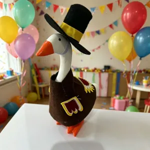 Desktop little goose figurine with Thanksgiving turkey costume hat set for holiday table decor.