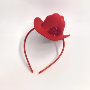 Close-up detail of red cowboy hat headband with sparkling rhinestone lips motif.