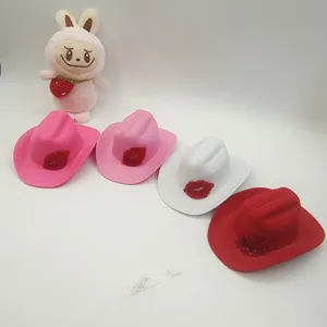 Close-up of colorful mini cowboy hats set with sparkling red lips decoration for party and fashion.