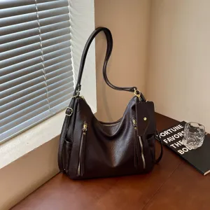 Brown soft leather hobo shoulder bag with zipper and small pouch detail for women.