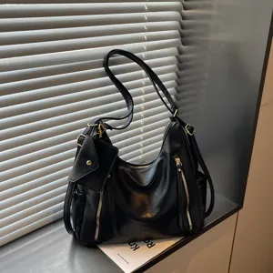Casual black leather shoulder bag with spacious capacity, chic zipper details and small pouch.