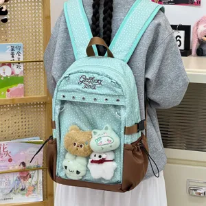 Zaino a pois verde menta con tasca frontale trasparente e graziosi ciondoli in peluche per scuola.