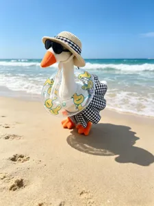 Beach style plush goose toy detail shot featuring cute hat, sunglasses and miniature swim ring.