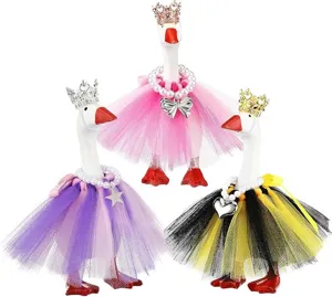 Grazioso set di oche decorative con gonne in tulle colorate, corone e collane di perle.