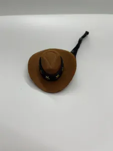 Close-up detail of the miniature brown cowboy hat with star band and elastic hanging rope.