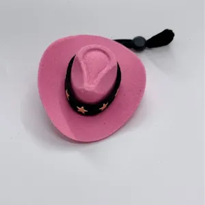 Mini pink cowboy hat with black star band and elastic chin strap for small dolls and toys.