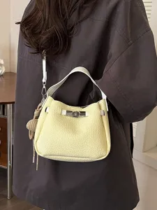 Élégant sac seau en cuir pour femme avec poignée supérieure et bandoulière jaune.