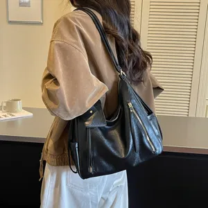 Black leather shoulder bag with chic zipper details, stylish commuter tote for daily wear.