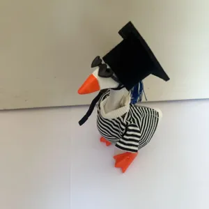 Cute 7-inch mini desktop graduation duck toy wearing black cap, sunglasses and striped outfit.