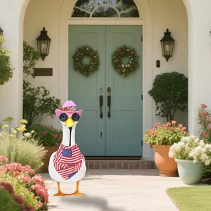 Porch goose decorative statue set with pink cowboy hat, sunglasses, and flag scarf.