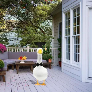 Porch big white goose graduation set with black mortarboard and bow tie ornament for decor.