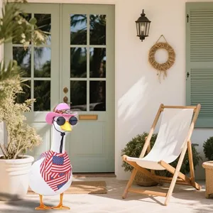 Porch goose statue detail showing cute pink cowboy hat, sunglasses and patriotic scarf.