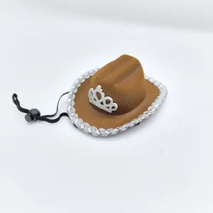 Mini brown cowboy hat with silver crown and glitter trim, ideal for party decor details.