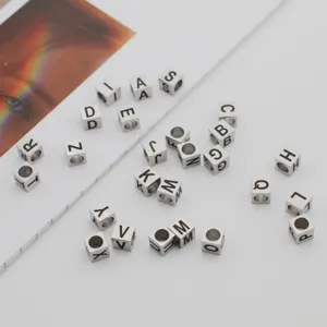 Detail view of 7mm stainless steel square alphabet beads, perfect for DIY jewelry making.