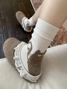 Cute cartoon cat mid-tube cotton socks for women with fluffy tail and lace trim design.