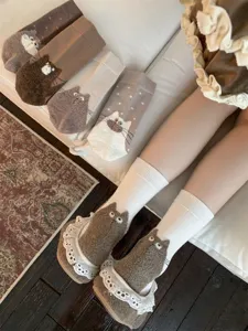 Cute plush cat design women's mid-tube cotton socks with fluffy cartoon tail illustrations.