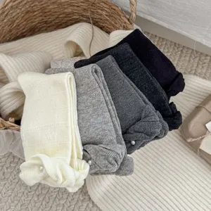 Cozy autumn winter women solid color fashion knit socks with pearl and lace bow details.