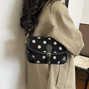 Gedetailleerd overzicht van retro polkadot schoudertas met flap en elegante vintage stijl.