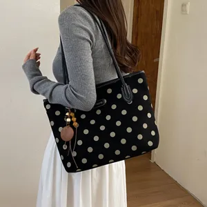 Detailed view of women canvas polka dot tote bag, large capacity shoulder handbag style.