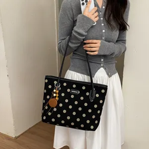 Stylish polka dot canvas tote bag with large capacity, perfect for daily commute and casual use.