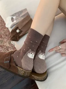 Fluffy cute cat design mid-tube cotton socks in warm brown color, detailed close-up lifestyle shot.