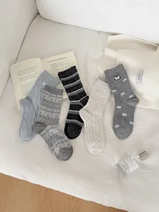 Vintage knit mid-tube socks set for women, cozy winter patterned fashion hosiery items.