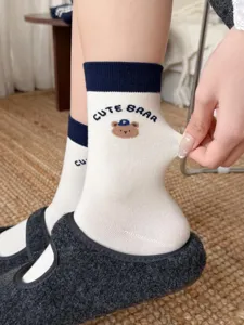 Cute cartoon bear mid-tube socks for women, sweet Japanese style with stretchy navy cuffs.
