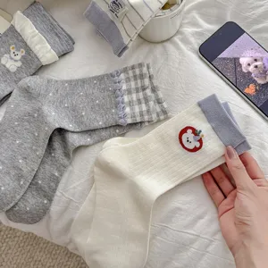Cute women's crew socks with sweet cartoon bear embroidery, retro plaid cuffs, and soft cotton fabric.